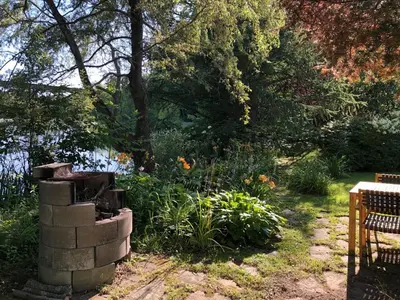 a garden with a stack of bricks and flowers at La Maison Jaune D'Eastman in Eastman