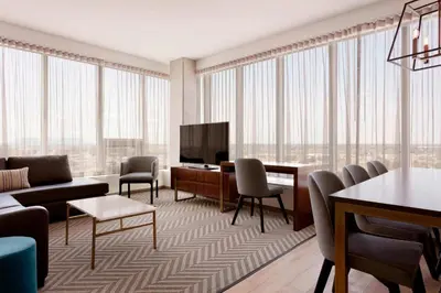 a living room with a couch and a television at Sheraton Saint-Hyacinthe Hotel in Saint-Hyacinthe