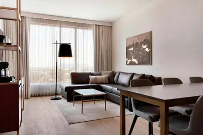 a living room with a couch and a table at Sheraton Saint-Hyacinthe Hotel in Saint-Hyacinthe