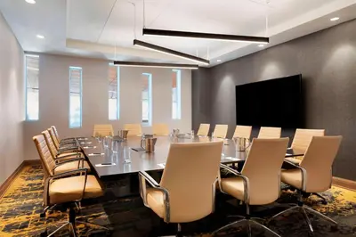 a conference room with a long table and chairs at Sheraton Saint-Hyacinthe Hotel in Saint-Hyacinthe