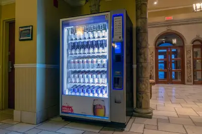 a vending machine full of water bottles in a building at Hotel Brossard in Brossard
