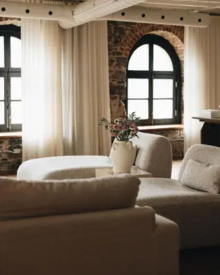 a living room with two couches and two windows at Saint Sulpice Lofts by Bakan - Old Montreal in Montréal