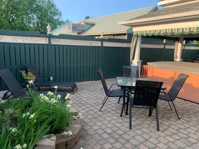 a patio with a table and chairs and a fence at Motel ANF in Drummondville