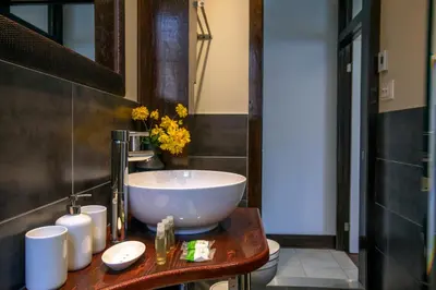 a bathroom with a large white bowl sink on a wooden counter at Lofts Jacques-Cartier Free Parking in Montréal