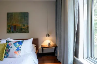 a bedroom with a bed and a table with a lamp at Lofts Jacques-Cartier Free Parking in Montréal
