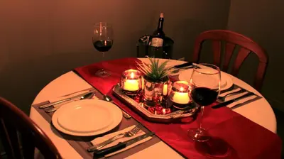 a table with glasses of wine and candles on it at Hôtel Val-des-Sources in Asbestos