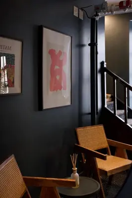 a living room with two chairs and a staircase at Maison Saint-Vincent By Maisons & co in Montréal