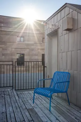 a blue bench sitting on top of a wooden deck at Maison Saint-Vincent By Maisons & co in Montréal
