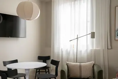 a dining room with a table and chairs at Maison Saint-Vincent By Maisons & co in Montréal