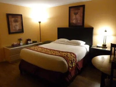 a bedroom with a large bed in a hotel room at Motel Becancour in Bécancour