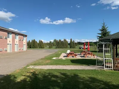 a picnic area with picnic tables and a playground at Motel Becancour in Bécancour