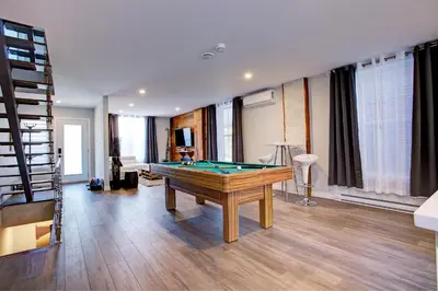 a living room with a pool table in it at Modern Townhouse with Rooftop Deck in Montréal