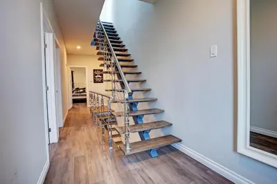 a spiral staircase in a house with wooden floors at Modern Townhouse with Rooftop Deck in Montréal