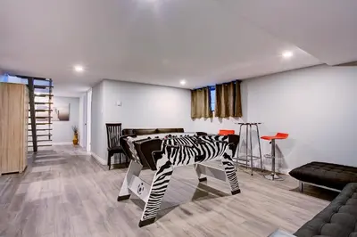 a living room with a zebra table in a room at Modern Townhouse with Rooftop Deck in Montréal