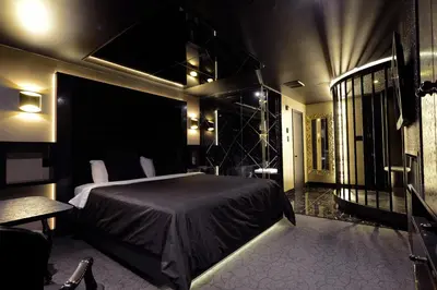 a bedroom with a bed in a room with lights at Le Fabreville Motel & Suites in Laval