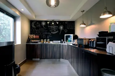 a restaurant counter with a chalkboard on the wall at Le Fabreville Motel & Suites in Laval