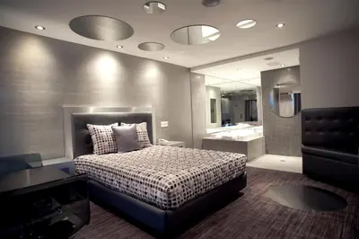 a bedroom with a large bed and a bathroom at Le Fabreville Motel & Suites in Laval