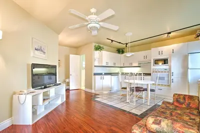 a kitchen and living room with a couch and a table at Motel R-100 in Longueuil