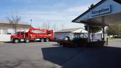 a red dump truck parked at a gas station at Motel R-100 in Longueuil