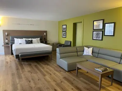 a hotel room with a bed and a couch at Hôtel Rive Gauche in Beloeil Village
