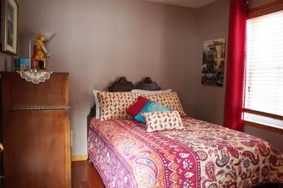 a bedroom with a bed with pillows on it at Le Gite A Margot in Bromont