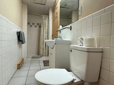 a bathroom with a toilet and a sink at Hotel Motel La Marquise in Sherbrooke