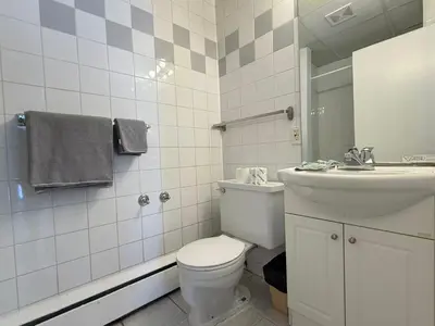 a bathroom with a toilet and a sink at Hotel Motel La Marquise in Sherbrooke