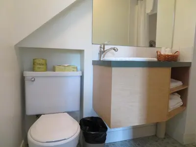 a bathroom with a toilet and a sink and a mirror at Motel & Hotel La Paysanne in Sherbrooke
