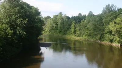 a river with trees on the side of it at Motel & Hotel La Paysanne in Sherbrooke