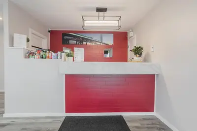 a red garage door with a red wall at Motel Champlain in Brossard