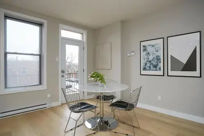 a dining room with a glass table and chairs at Montreal Contemporary Apartment Free Parking in Montréal