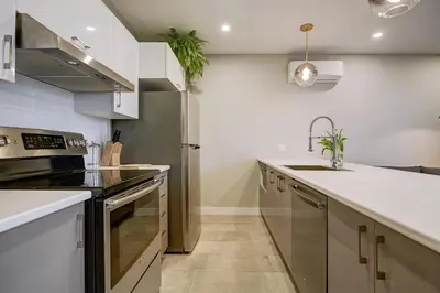 a kitchen with a sink and a stove at Montreal Contemporary Apartment Free Parking in Montréal