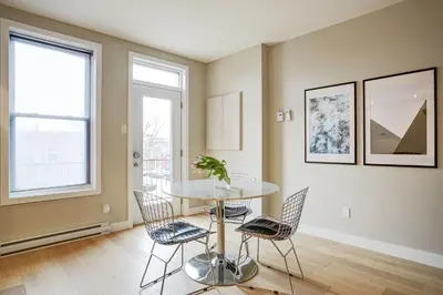 a dining room with a table and chairs at Montreal Contemporary Apartment Free Parking in Montréal