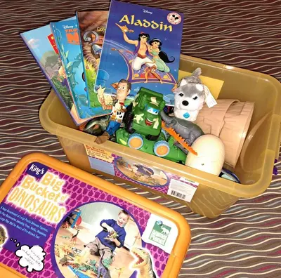 a plastic container filled with toys and books at Motel Bonsoir in Joliette