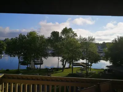 a view of a lake from a porch at Condo de L'Oberge in Magog-Orford