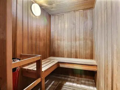 a sauna with a wooden paneled walls at Condo de L'Oberge in Magog-Orford