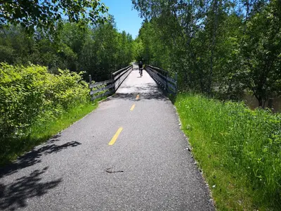 a person is riding a bike on a road at Condo de L'Oberge in Magog-Orford