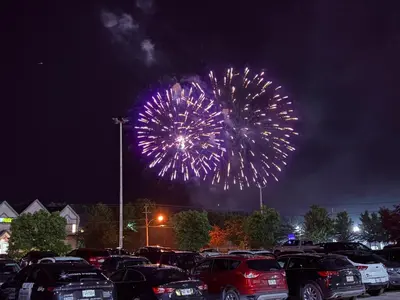 a fireworks display with cars parked in a parking lot at Days Inn by Wyndham Ste. Helene-de-Bagot in Sainte-Hélène-de-Bagot