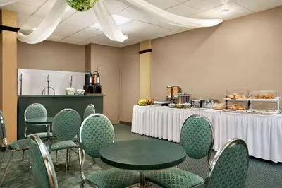 a room with tables and chairs and a table with food on it at Days Inn by Wyndham Ste. Helene-de-Bagot in Sainte-Hélène-de-Bagot