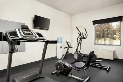 a room with two exercise bikes and a television at Days Inn by Wyndham Ste. Helene-de-Bagot in Sainte-Hélène-de-Bagot