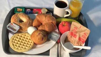 a tray with breakfast foods on a table at Days Inn by Wyndham Ste. Helene-de-Bagot in Sainte-Hélène-de-Bagot