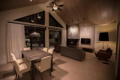 a living room with a dining room table and a couch at Kinipi Spa Nordique & Hebergement in Trois-Rivières