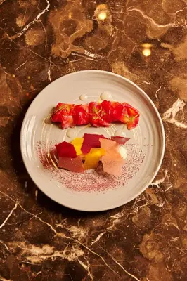 a white plate with food on a table at The Ritz-Carlton, Montreal in Montréal