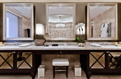 a bathroom with two sinks and two mirrors at The Ritz-Carlton, Montreal in Montréal