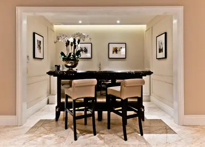 a dining room with a black table and chairs at The Ritz-Carlton, Montreal in Montréal