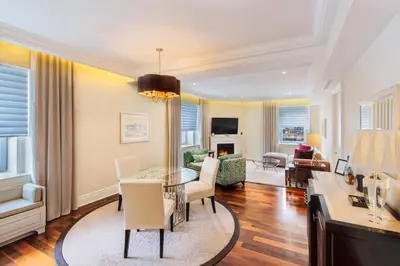 a dining room and living room with a table and chairs at The Ritz-Carlton, Montreal in Montréal