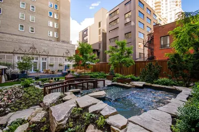 a garden with a pool in the middle of a city at The Ritz-Carlton, Montreal in Montréal