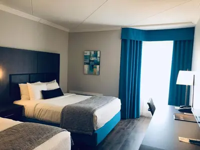 a hotel room with two beds and a window at Best Western Laval-Montreal & Conference Centre in Laval