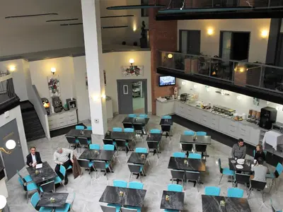 a group of people sitting at tables in a building at Best Western Laval-Montreal & Conference Centre in Laval
