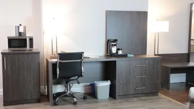 a desk with a microwave and a chair in a room at Best Western Laval-Montreal & Conference Centre in Laval